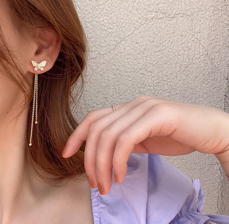 One pair of long butterfly stud earrings.