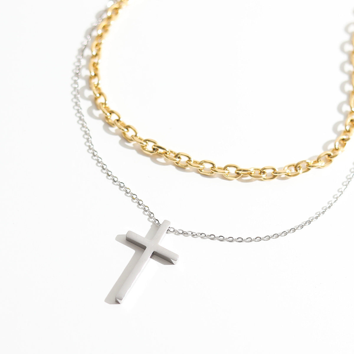 Cross pendant stacked with titanium steel necklace