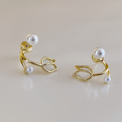 A pair of tulip flower pearl stud earrings.