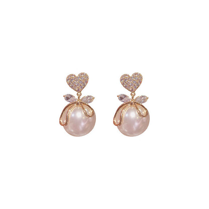 Peach heart big pearl earrings.