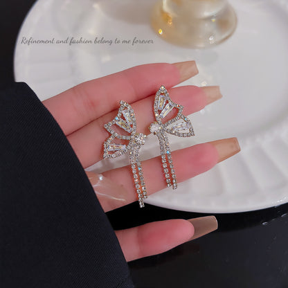 Diamond bow fringed earrings