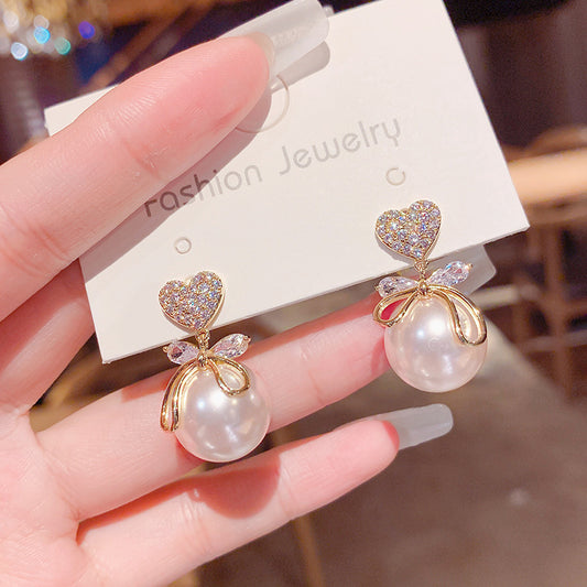 Peach heart big pearl earrings.