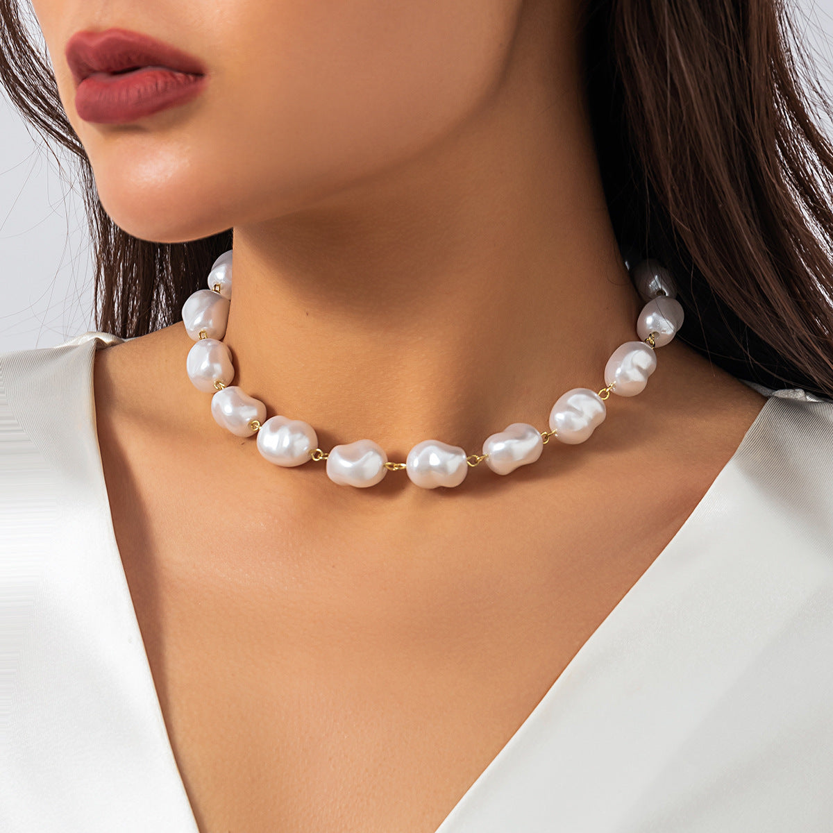 Imitation pearls stacked with woven baroque necklaces