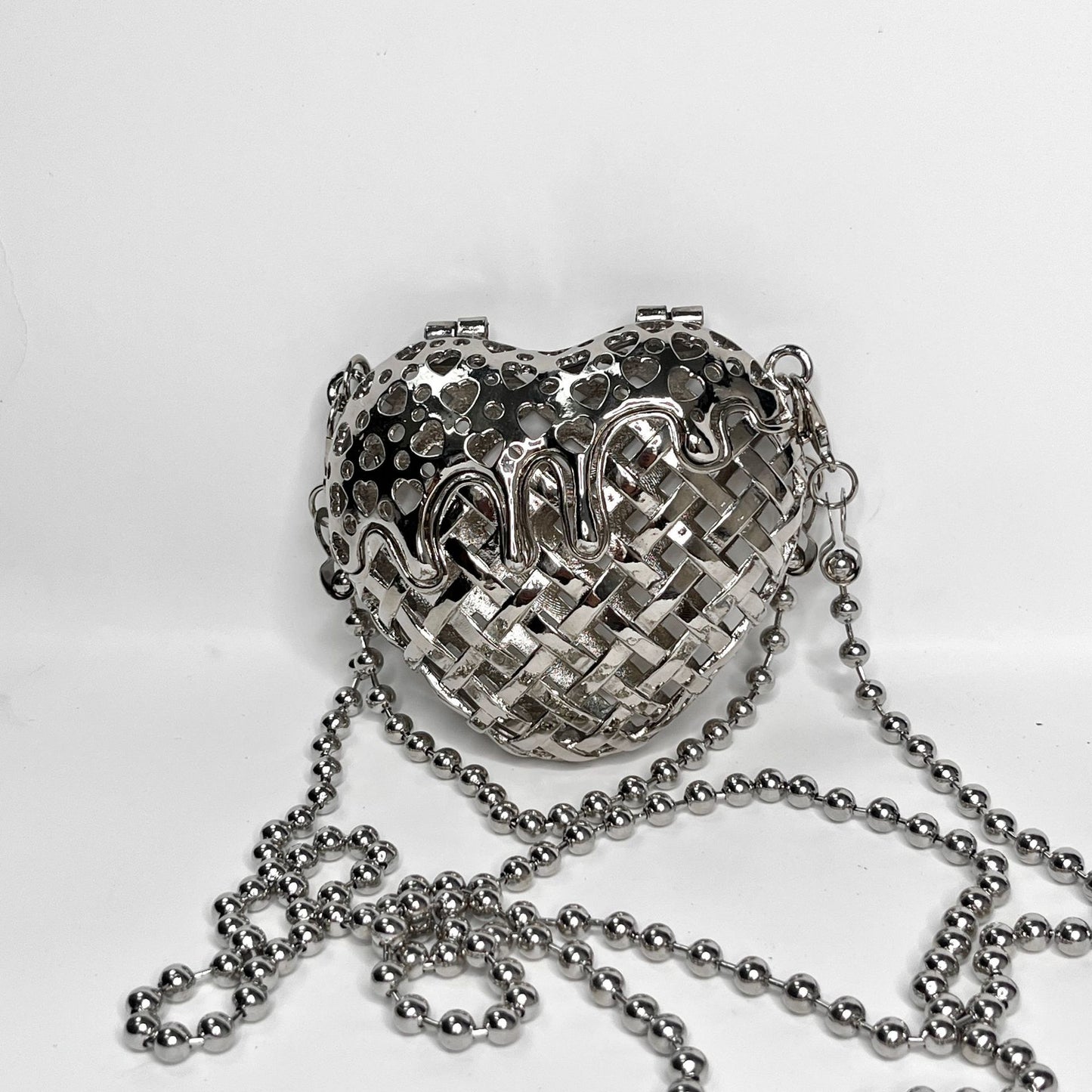 Heart-shaped metal hollow box bag.