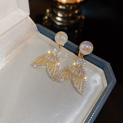 Pearl fishtail sparkling diamond earrings.