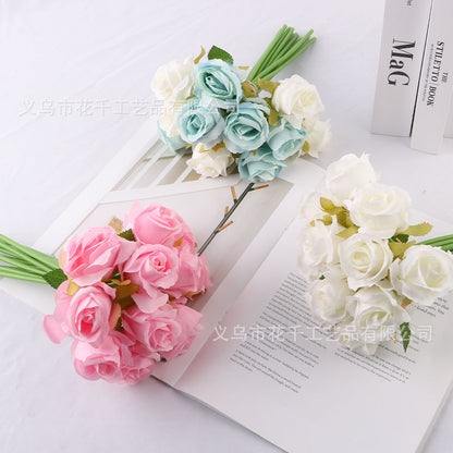 Bride holding bouquet of simulated small roses