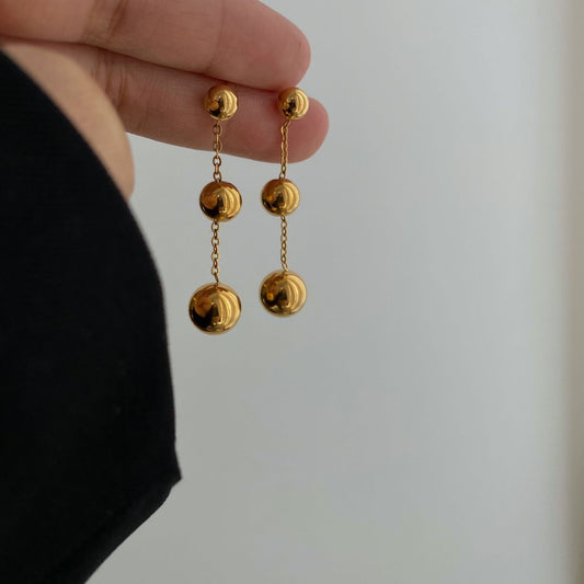 Three gold bead fringed earrings.