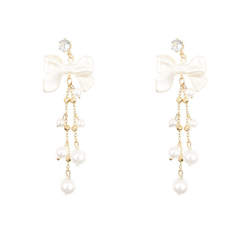 Long bow pearl fringed earrings