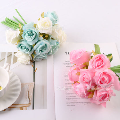 Bride holding bouquet of simulated small roses