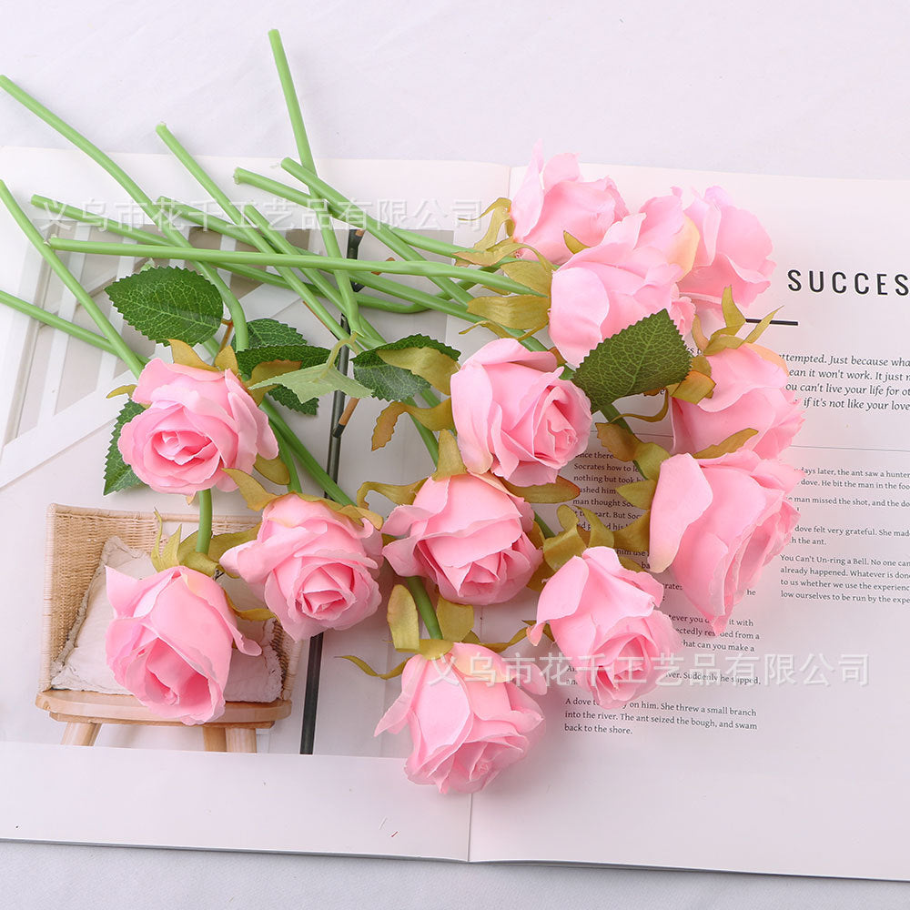 Bride holding bouquet of simulated small roses