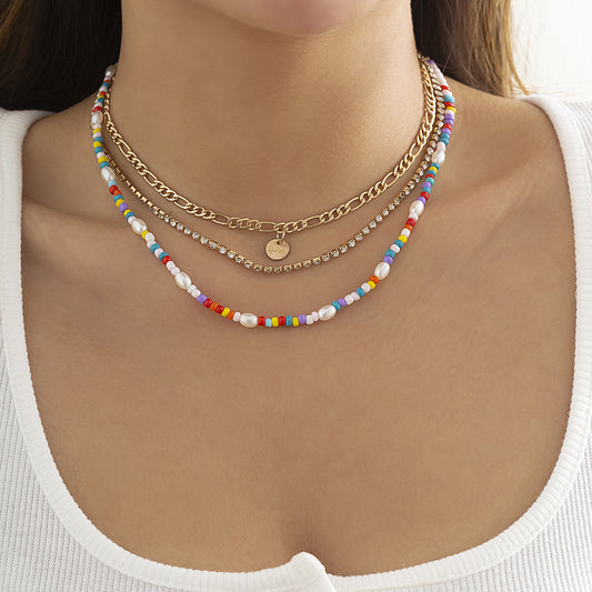 Colored rice beads stacked with ethnic style necklaces