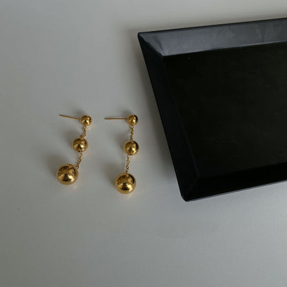 Three gold bead fringed earrings.