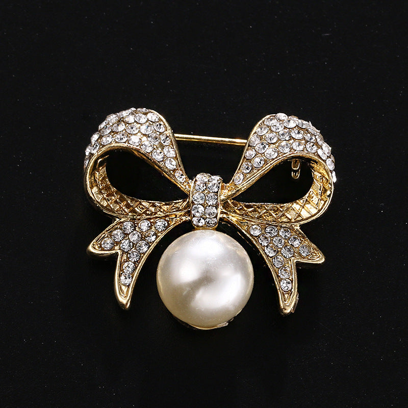 Bow pearl brooch