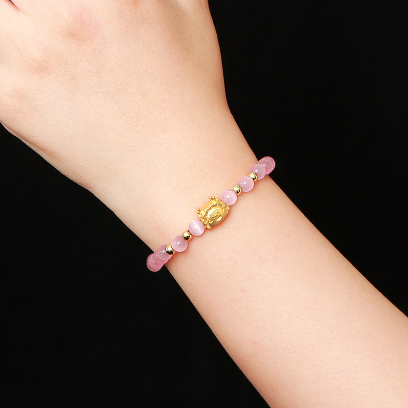 Pink and white cat's eye stone dragon steamed dumpling bracelet.