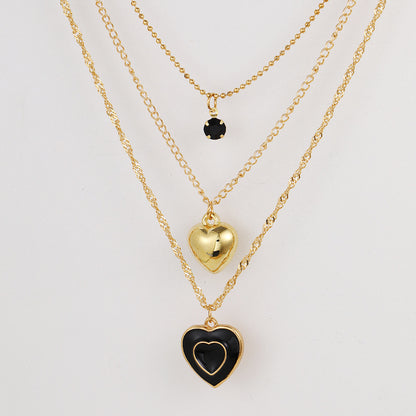 Multi-layered black oil-dripping peach heart necklace