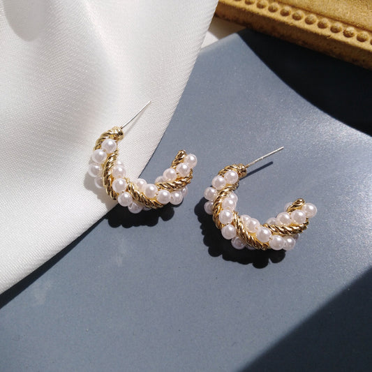 C-shaped earrings, pearl earrings.