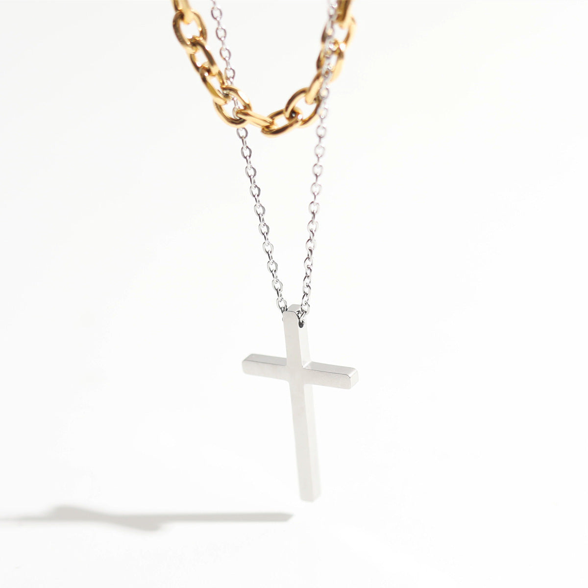 Cross pendant stacked with titanium steel necklace