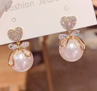 Peach heart big pearl earrings.