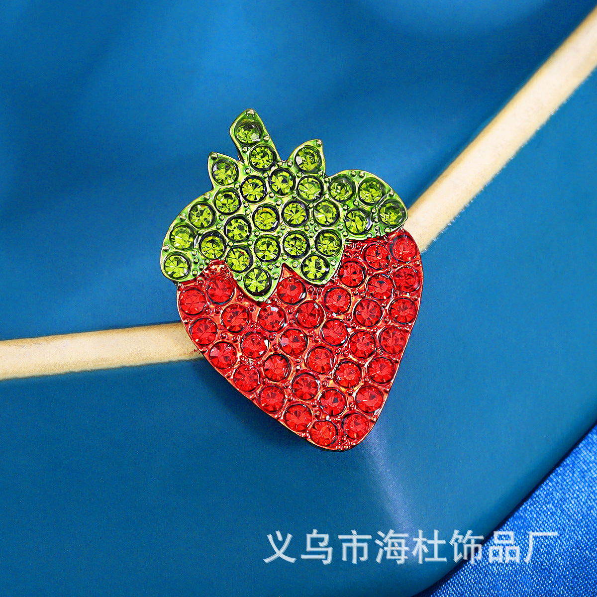 Simple red strawberry brooch with diamonds