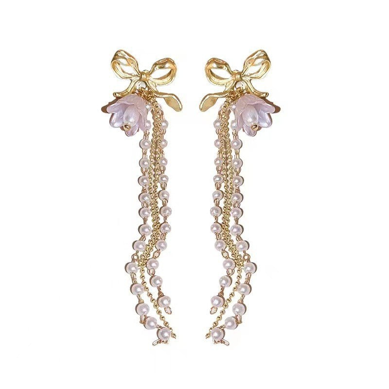 Long bow pearl fringed earrings.